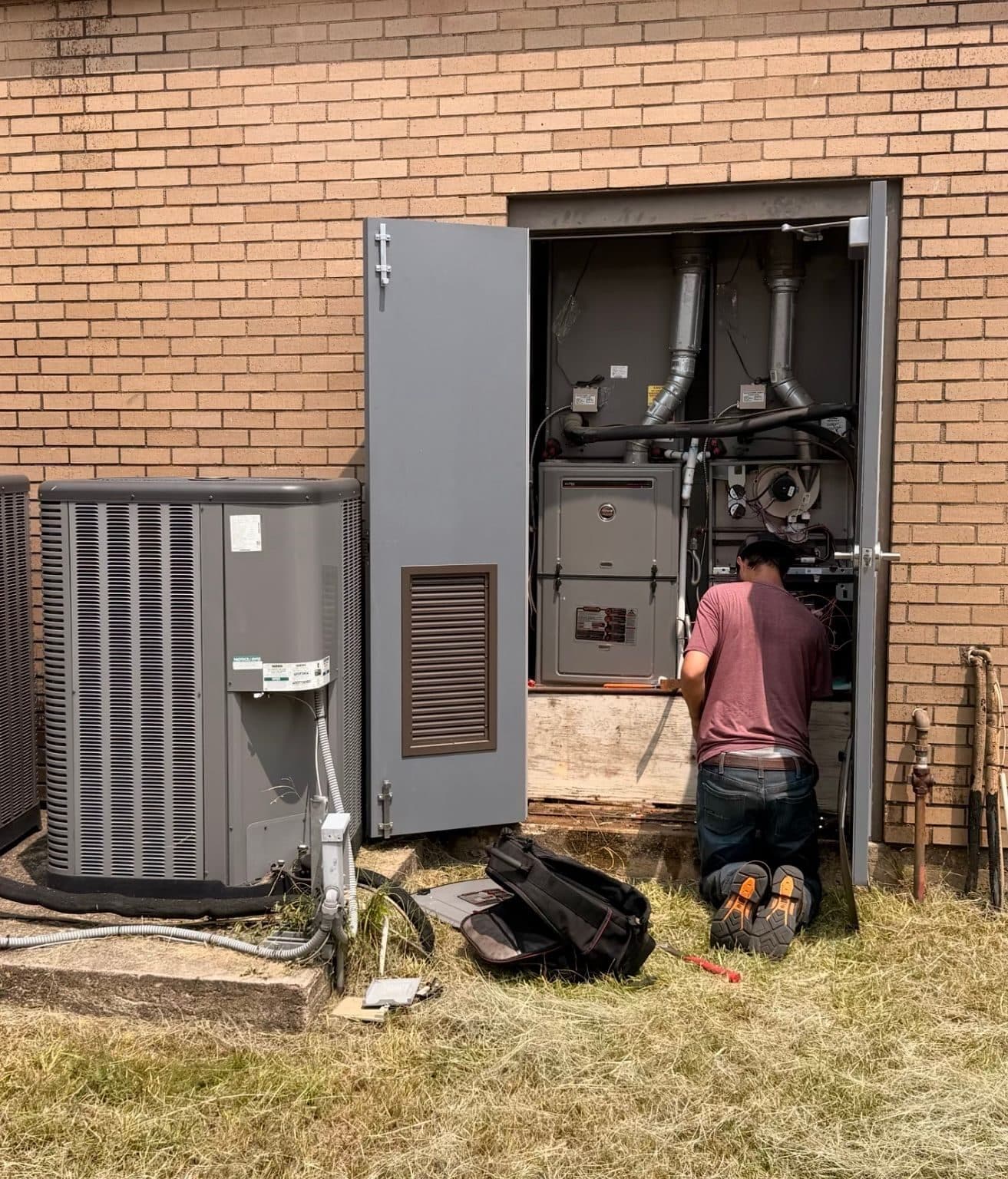 Repair It Guys technician servicing a residential HVAC system